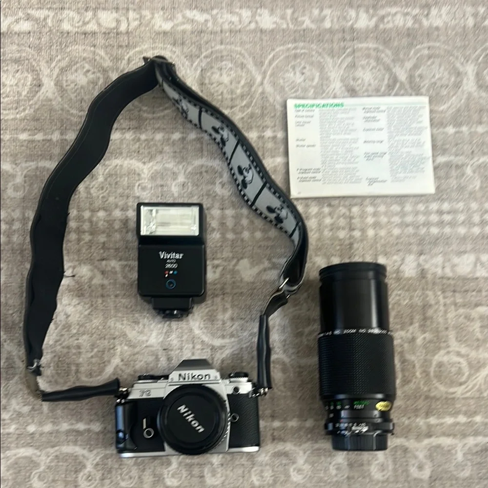 Nikon Black & Silver Camera with Vivitar Flash